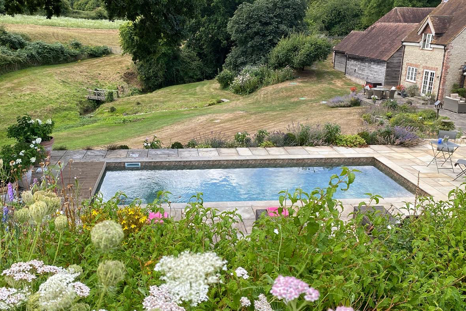 Swimming Pool. Garden Design in South Downs. Sawn Sandstone terrace.